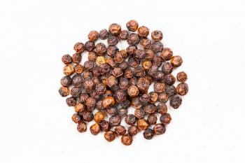 top view of pile of red kampot pepper close up on gray ceramic plate