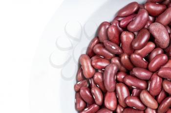 top view of part of round bowl with kidney beans isolated on white background