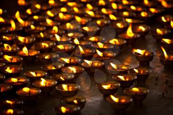 Burning candles in Buddhist temple. Tsuglagkhang complex,  McLeod Ganj, Himachal Pradesh, India