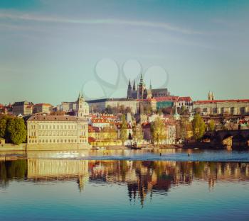 Vintage retro hipster style travel image of Mala Strana and  Prague castle over Vltava river. Prague, Czech Republic