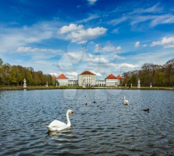 Swan in fountain in Grand Parterre (Baroque garden) and the rear view of the Nymphenburg Palace. Munich, Bavaria, Germany