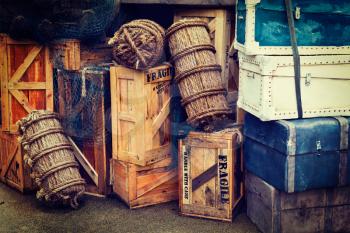 Retro hipster style travel image of vintage luggage and crates