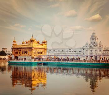 Vintage retro effect filtered hipster style travel image of Sikh gurdwara Golden Temple Harmandir Sahib. Amritsar, Punjab, India
