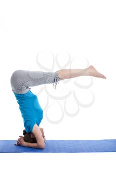Yoga - young beautiful woman  yoga instructor  doing Lowered Bound Headstand (Salamba sirsasana with Urdhva Dandasana) exercise
 isolated on white background