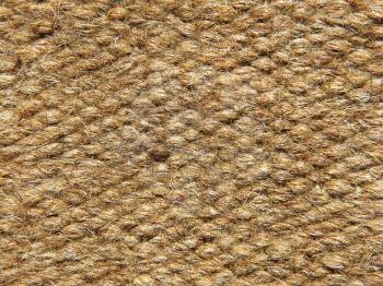 Rough brown camel wool fabric texture taken closeup as background.