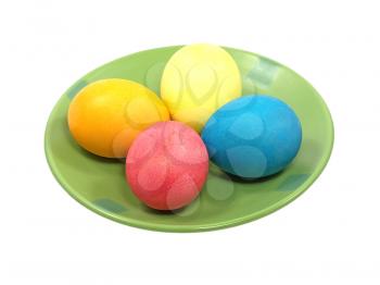 Multicolored easter eggs on a plate isolated on white background.