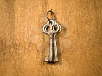 Two old keys on a wooden wall.