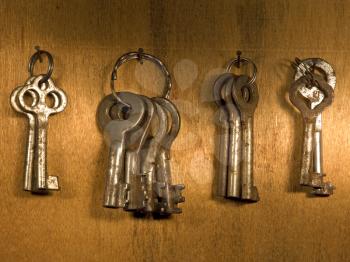 Old rusty keys on a wooden wall.