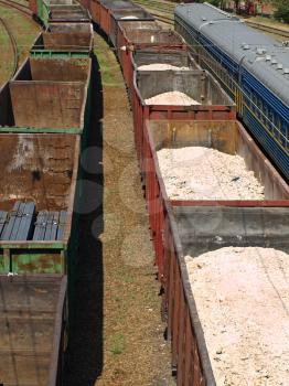 Freight trains of metal profile and sulfur on a rails.