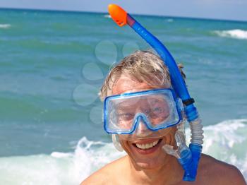 Diver wearing a mask taken closeup on summer seaside.
