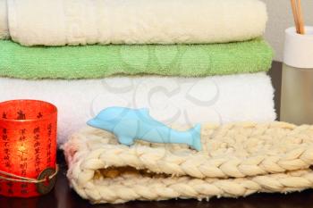 Towel stack, bast and soap in the form of a dolphin.