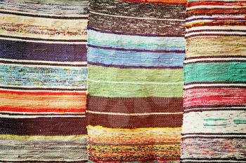 Multicolored handmade rugs taken closeup as abstract background.Toned image.