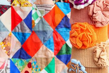 Multicolored clothing accessory on colorful patchwork quilt abstract background.