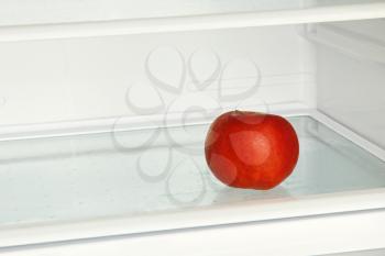 Fresh red apple in domestic refrigerator taken closeup.
