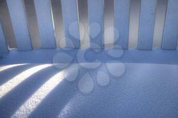 White Picket Fence in Winter with snow reflection shadow