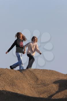 Young Girls Playing in Gravel