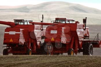 Two combines sitting idle in field