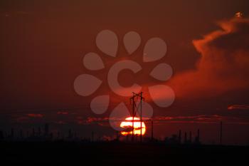 Sun setting behind Regina Oil Refinery in Saskatchewan