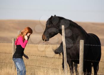 Young girl with horse in scenic Saskatchewan