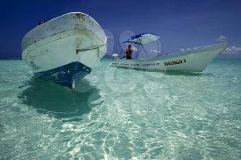 two boats in the blue lagoon of sian kaan in mexico