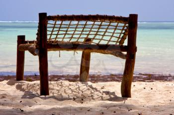 seat deck beach rope sand and sea in zanzibar coastline