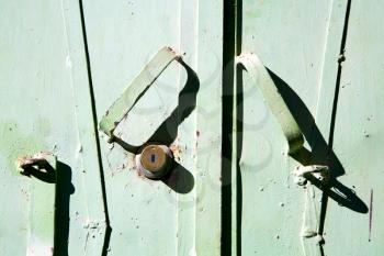metal   green    morocco in    africa the old wood  facade home and rusty safe padlock 
