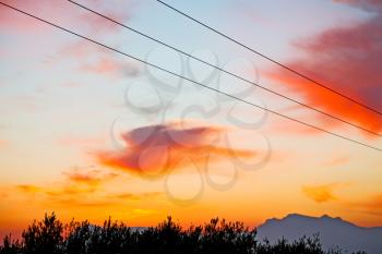 mountain in morocco africa and red sunrise current cables   power pylon