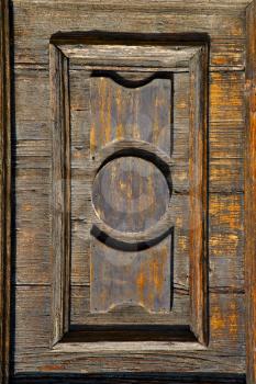 castronno  varese abstract  rusty brass brown knocker in a  door  closed wood lombardy italy