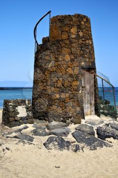 tower spain  hill yellow  beach    black rocks in the   lanzarote 
