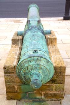 bronze cannon in africa morocco  green  and the old pavement

