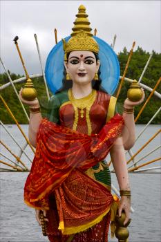 marble  wood statue of a Hinduism  women  Shiva vishnu Brahma in a temple near a lake in mauritius africa
