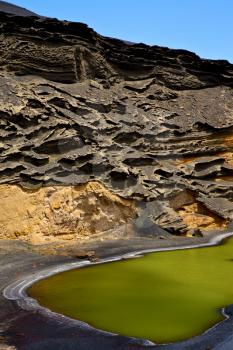 sky  water  in el golfo lanzarote spain musk pond rock stone  coastline and summer 
