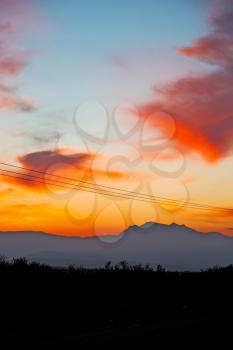mountain in morocco africa and red sunrise current cables   power pylon