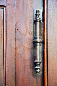 vedano olona abstract  rusty brass brown knocker in a  door  closed wood lombardy italy  varese