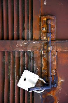 abstract cross   steel  padock in a   closed rusty door   varese italy mornago