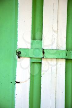 metal   green    morocco in    africa the old wood  facade home and rusty safe padlock 