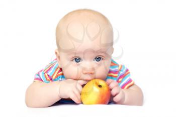 Photo of lying little boy with red-yellow apple