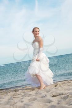 Happy bride on the sandy beach