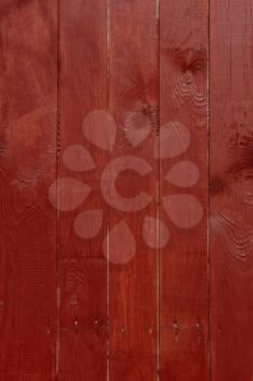 Parallel vertical wooden planks, painted in red