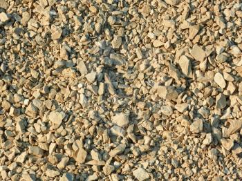 Crushed stone in bright sunlight as a texture