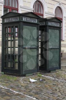 Two old green retro street public call-box for telephone calls 7675