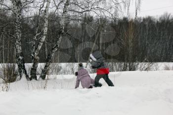 Two girls walking and playing in the winter forest and having fun with snow 29995