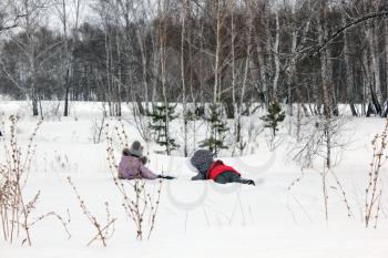 Two girls walking and playing in the winter forest and having fun with snow 30001