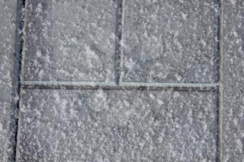 The snow-covered sidewalk tile 30418