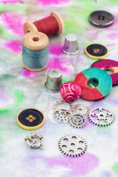 accessories of beads and threads for needlework on wooden plank