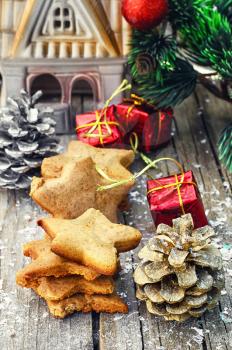 Home-baked star-shaped Christmas decorations on wooden background