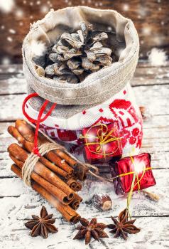 Christmas bag with fir-cone,cinnamon and Christmas decorations.Image is tinted