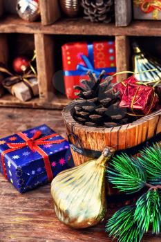Spruce ,wooden bucket with heater and gifts on the background of Christmas decorations