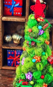 Decorative Christmas tree on the background of festive vintage decorations