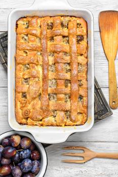 Baked according to traditional recipe meat pie with plums